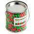 A metal bucket filled with red and green chewy fruit candies. It features a festive label with trees.