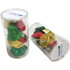 A clear tube filled with wrapped chocolates in red, green, and gold shapes resembling Christmas bells.