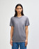 A grey American Apparel tri-blend T-shirt on a model, featuring short sleeves and a round neckline.