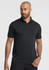 A men's short sleeve polo in black, featuring a collar and a logo. Model is posing.