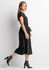 A black midi dress with short sleeves and a tied waist, featuring a model walking in profile.