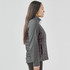 A women's softshell jacket in grey, featuring a quilted design and a zip closure. The jacket includes a logo.