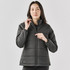A black puffer jacket with a zip, featuring a high collar and a fitted design. It has a logo on the sleeve.