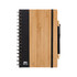 A bamboo and black spiral notebook with an elastic band and pen attached. It features a logo on the front cover.