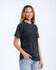 A dark mineral wash adult t-shirt featuring a relaxed fit and short sleeves, displayed by a smiling model.