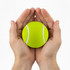 A bright yellow tennis ball is held gently between two hands. The ball features white stripes.