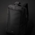 A black Swiss Peak convertible travel backpack with adjustable shoulder straps and a front compartment, featuring a logo.