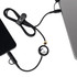A black charging cable with a circular connector, linking a device to a laptop, featuring a logo.