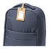 A navy backpack with a cork luggage tag attached, featuring a blank area for information.