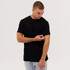 A black short-sleeve t-shirt is worn by a model adjusting the sleeve, set against a plain background.