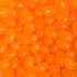 A close-up of bright orange jelly beans in various shapes and sizes, glossy and eye-catching in appearance.