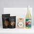 A drink bottle of white wine accompanied by salt pretzels, salted nuts, and caramel fudge, all in branded packaging.