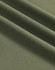 A close-up of soft, textured fabric in an olive green shade, showcasing its fine pique weave.