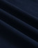A close-up of navy ultrafine cotton pique fabric with textured folds. It features a subtle branding logo.