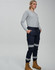 Cotton stretch drill cuffed work pants in navy with reflective tape, worn by a model with a grey long-sleeve top and boots.