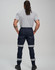 Cotton stretch drill cuffed work pants in navy with reflective tape, viewed from behind on a model.