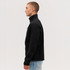 A black softshell jacket with a high collar, displayed from the side view, featuring a logo.