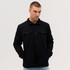 A black Studio Canvas Jacket with a collared neck and button closure, featuring two front pockets.