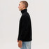 A side view of a black fleece 1/4 zip jumper, featuring a high collar and a relaxed fit. It has a logo on the chest.