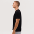 A classic black tee displayed on a model from the side, featuring short sleeves and a simple design.