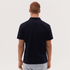 A man wearing a dark navy polo shirt, displayed from the back, with a simple design and a logo on the collar.