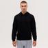 A black hooded sweatshirt featuring a front pouch pocket and drawstrings, worn by a model.