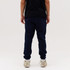 Navy blue track pants are displayed, featuring a casual fit and elastic cuffs, paired with a black shirt and light sneakers.