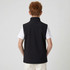 A black youth softshell vest with a high collar, worn over a white shirt, seen from the back.