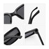 A pair of vintage rectangle sunglasses in glossy black, showcasing details of the frames and arms.