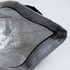 A grey lunch bag with a silver insulated interior and a zip closure, featuring a black handle.
