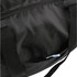 A packable travel duffel bag in black, featuring a zippered pocket and sturdy handles. It has a logo.