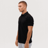 A black polo shirt with a collar, shown on a model from the side. The shirt features a logo.