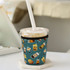 A drink bottle sleeve in teal with various drink illustrations, designed to insulate and hold cups.