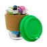 A clear glass coffee cup with a cork band and a green silicone lid, filled with colourful jelly beans.