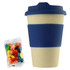 A reusable coffee cup in cream with a navy silicone sleeve, accompanied by a pack of colourful jelly beans.