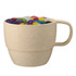 A reusable wheat straw cup in a light beige colour filled with colourful jelly beans. It features a handle and a logo.