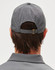 A grey cap with a laser cut design, featuring a rear adjustable strap and a logo.