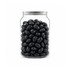 A clear jar filled with shiny black jelly beans. The jar has a metal lid and features a logo.