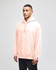 A pink pullover hooded sweatshirt with a front pocket and a logo, modelled by a person.
