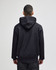 A black hooded sweatshirt with a kangaroo pocket, featuring a logo on the back, displayed from the rear.