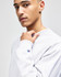 A grey Champion Reverse Weave® adult crew sweatshirt with a logo on the sleeve, modelled by a young man.