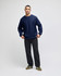 A navy blue sweatshirt with a crew neck and long sleeves, styled with dark pants and green shoes. The sweatshirt features a logo.