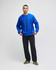 A blue Champion Reverse Weave® adult crew sweatshirt worn with black pants and green shoes, featuring a logo on the sleeve.