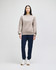 A model wears a beige Champion Powerblend® adult crewneck sweatshirt paired with navy trousers and white sneakers.