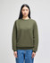 A green Champion Powerblend® adult crewneck sweatshirt displayed on a model, featuring a logo on the sleeve.