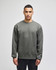 A grey sweatshirt featuring a crewneck design and a logo on the sleeve.