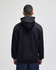 A black pullover hooded sweatshirt featuring a logo, viewed from the back.