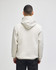 A hooded sweatshirt in cream colour, featuring a logo, viewed from the back.