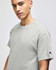 A grey Champion adult short-sleeve t-shirt with a logo on the sleeve.