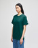 A short-sleeve t-shirt in dark green, featuring a logo on the sleeve, displayed on a model.